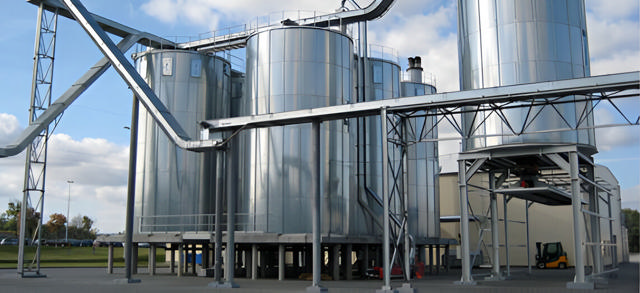 A silo system outside of a industrial building 